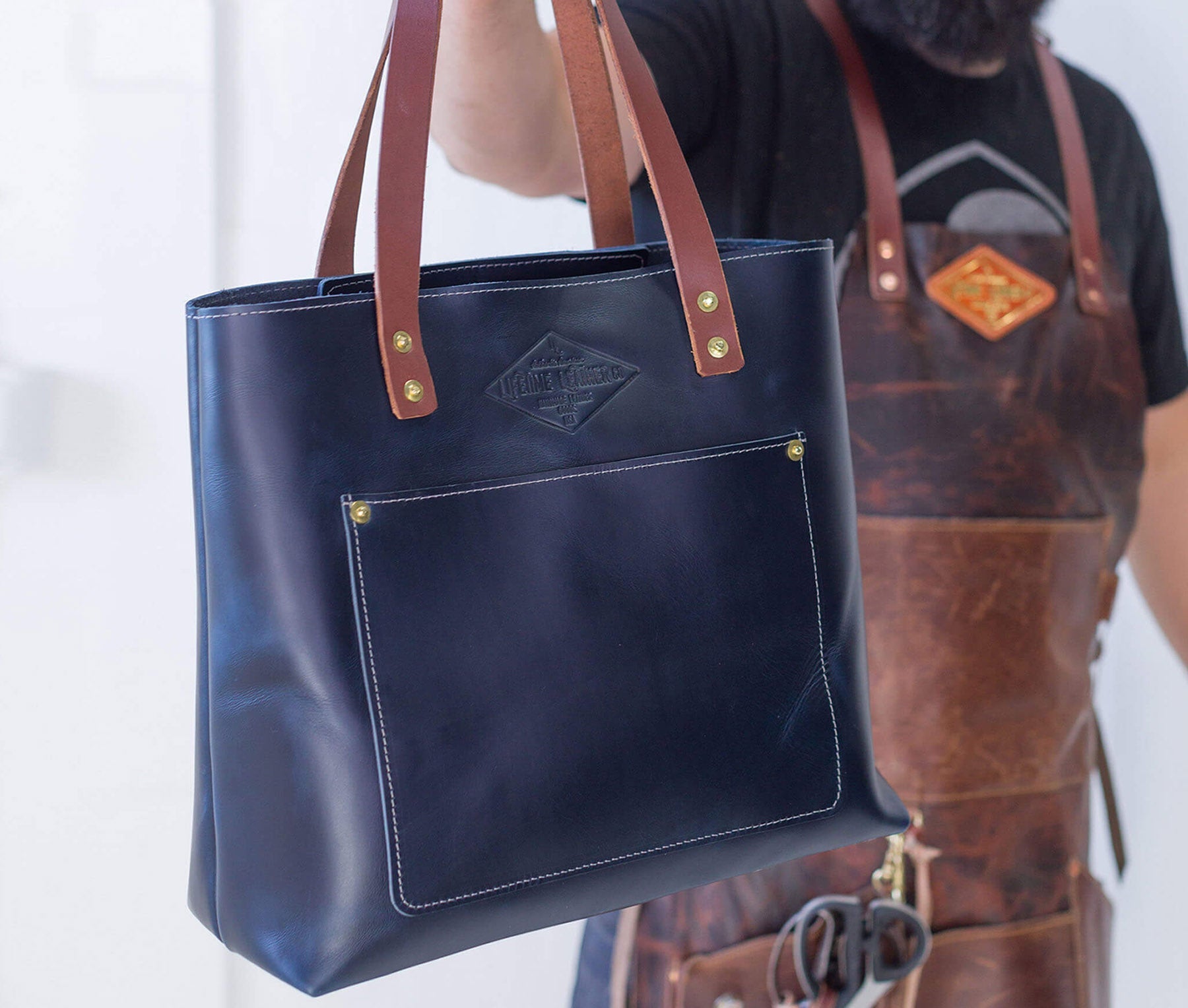 Deluxe Lifetime Tote in premium dyed leather, spacious design with interior pockets, perfect for everyday use.