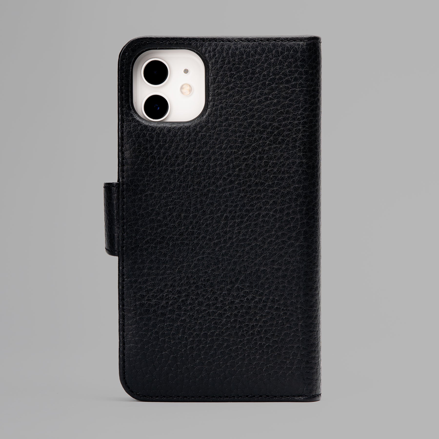 Detachable iPhone Case made from premium full-grain leather with credit card slots and currency pocket, showcasing its sleek design and antique brass hardware.