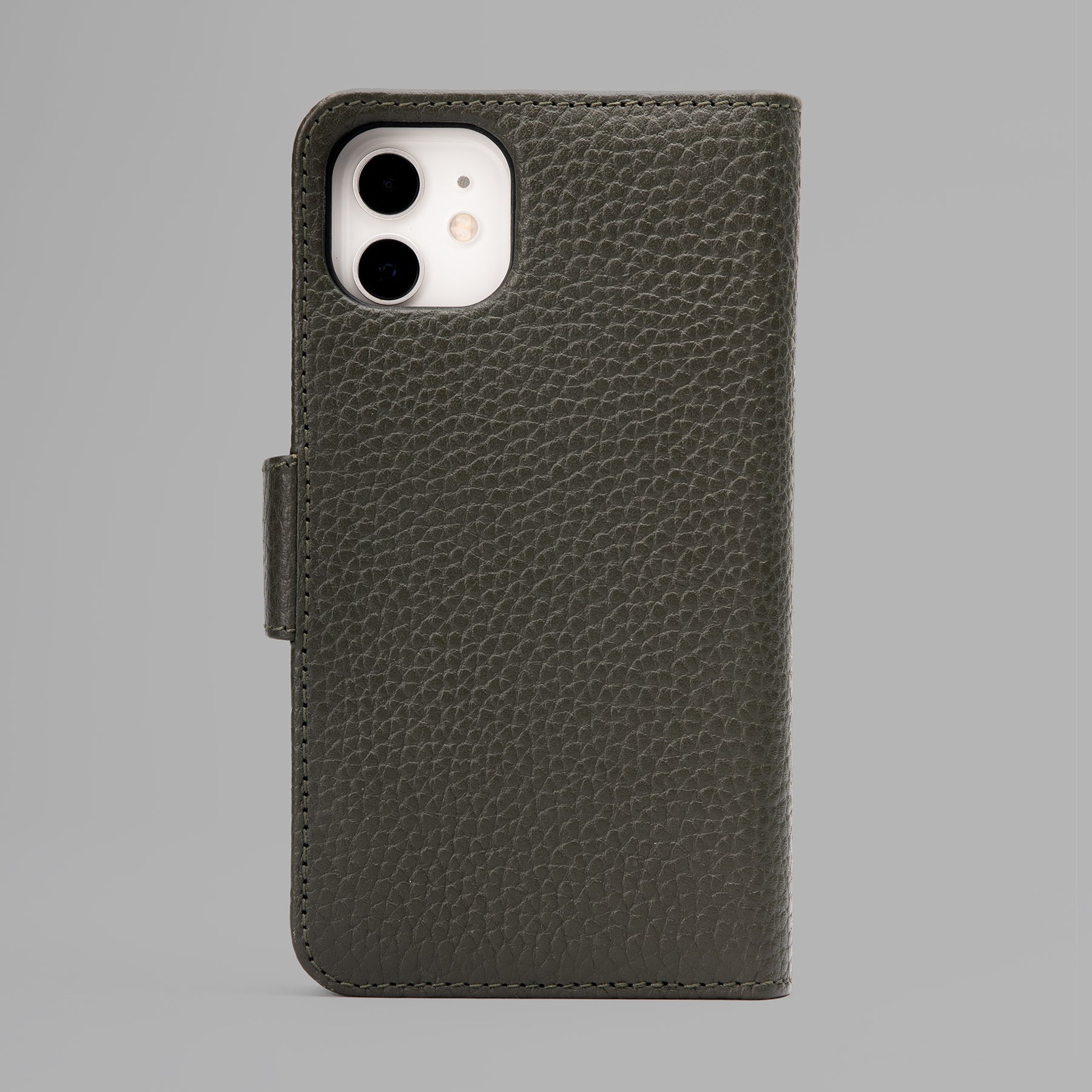 A stylish detachable iPhone case made of premium full-grain leather, featuring credit card slots and a currency pocket, showcasing its sleek design.