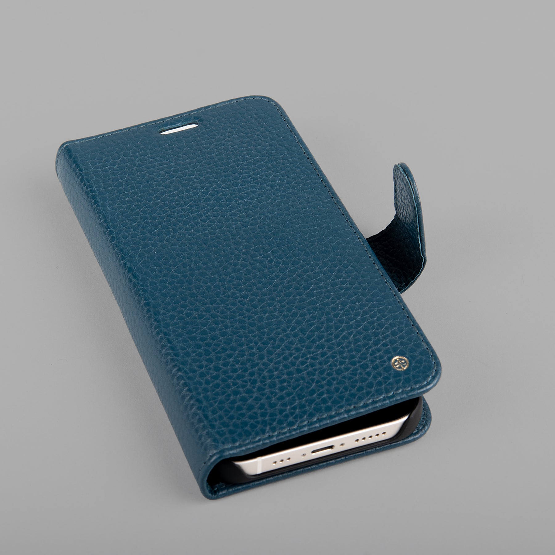 A stylish detachable iPhone case made of premium full grain leather, featuring credit card slots and a currency pocket, showcasing its sleek design.