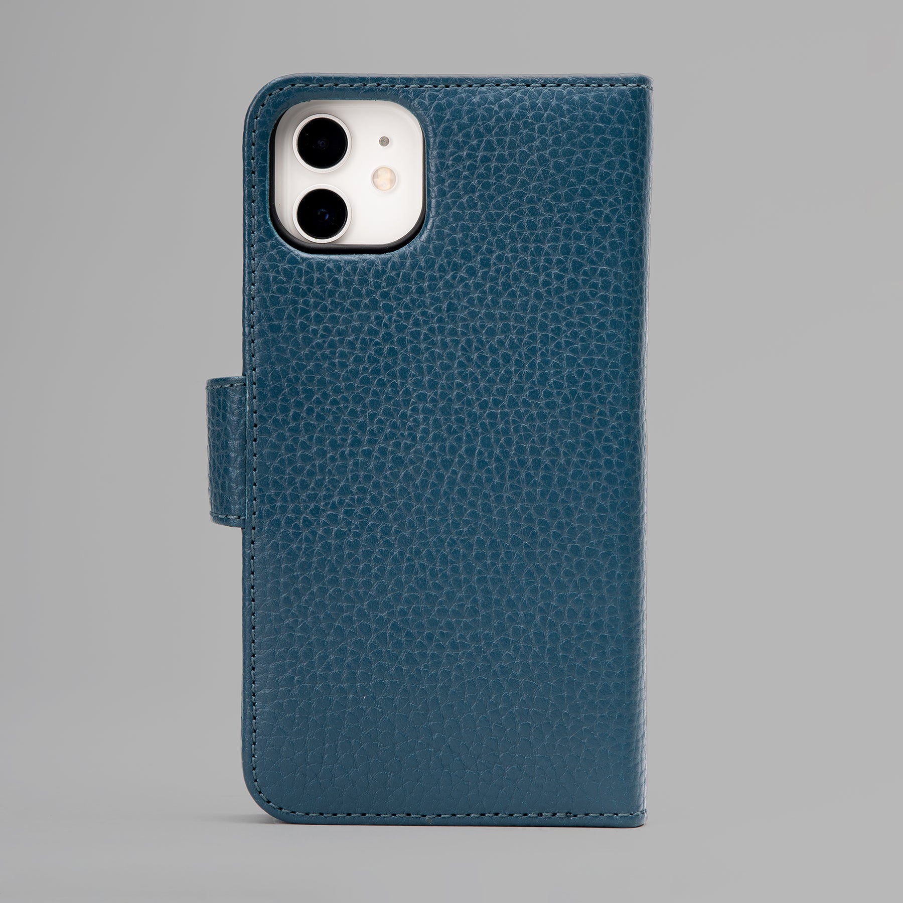 A stylish detachable iPhone case made of premium full grain leather, featuring credit card slots and a currency pocket, showcasing its sleek design.