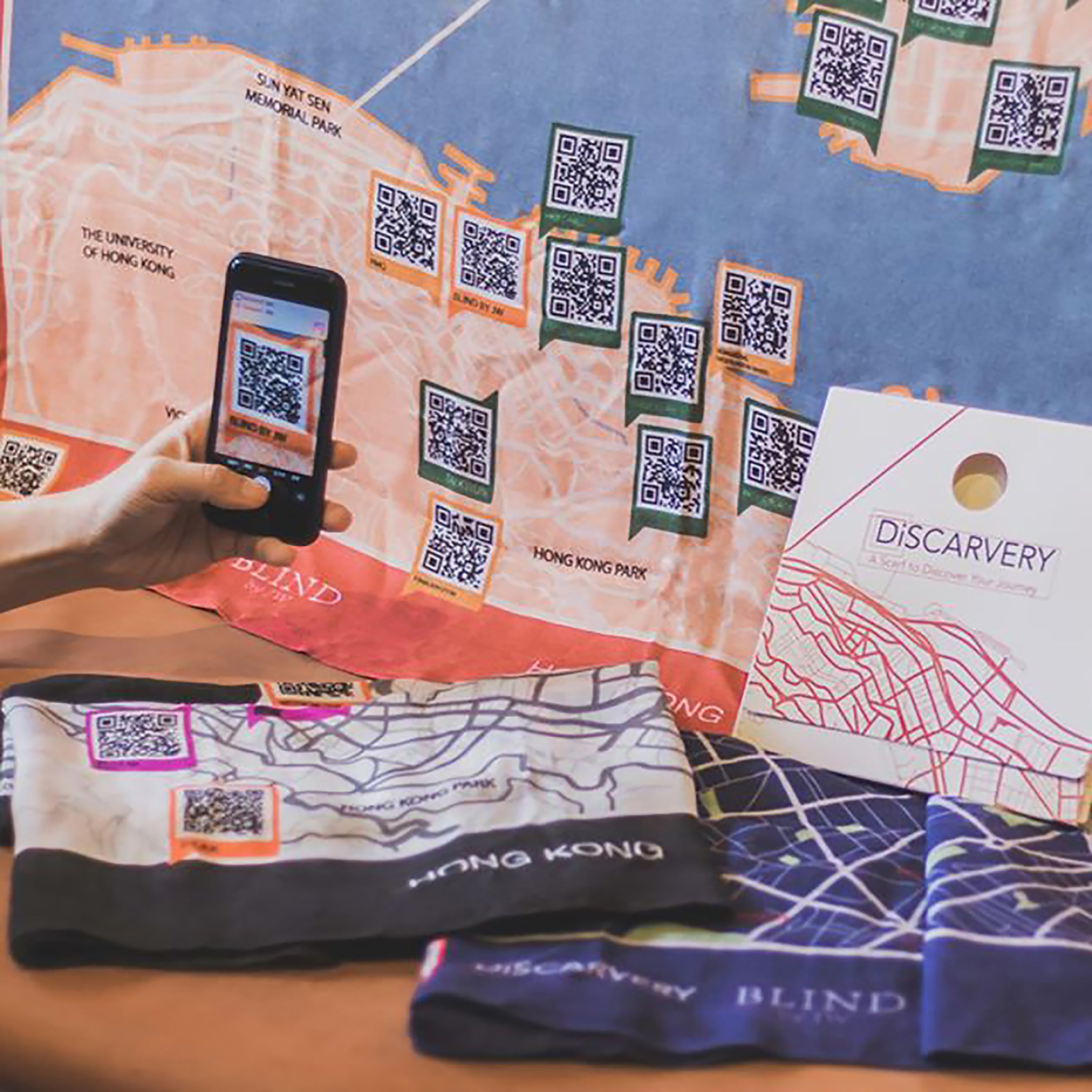 Discarvery map scarf featuring a unique map design with QR codes for travel inspiration and experiences.