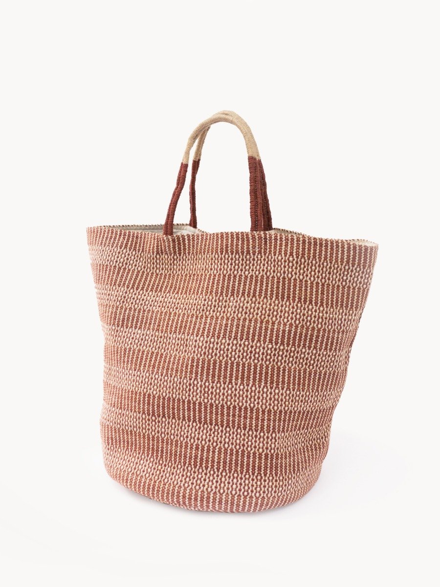 Dobi Shoulder Tote in Brown, featuring a spacious design and round bottom, handmade from jute-cotton fabric with off-white handle accents.