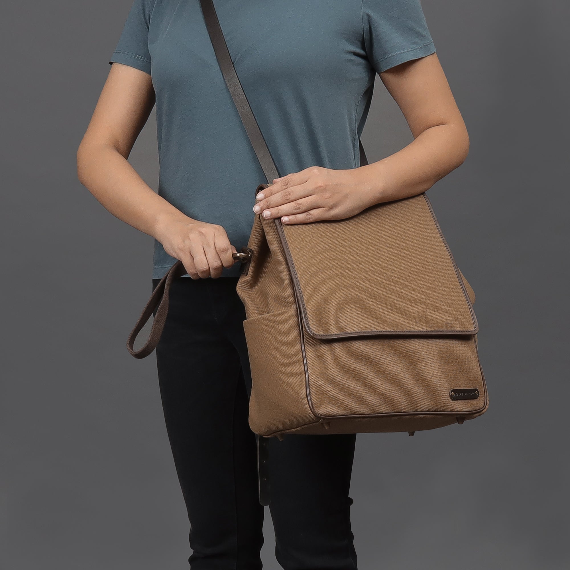 Stylish Donna Canvas Diaper Bag in durable cotton canvas with multiple pockets and leather straps, perfect for parents on the go.