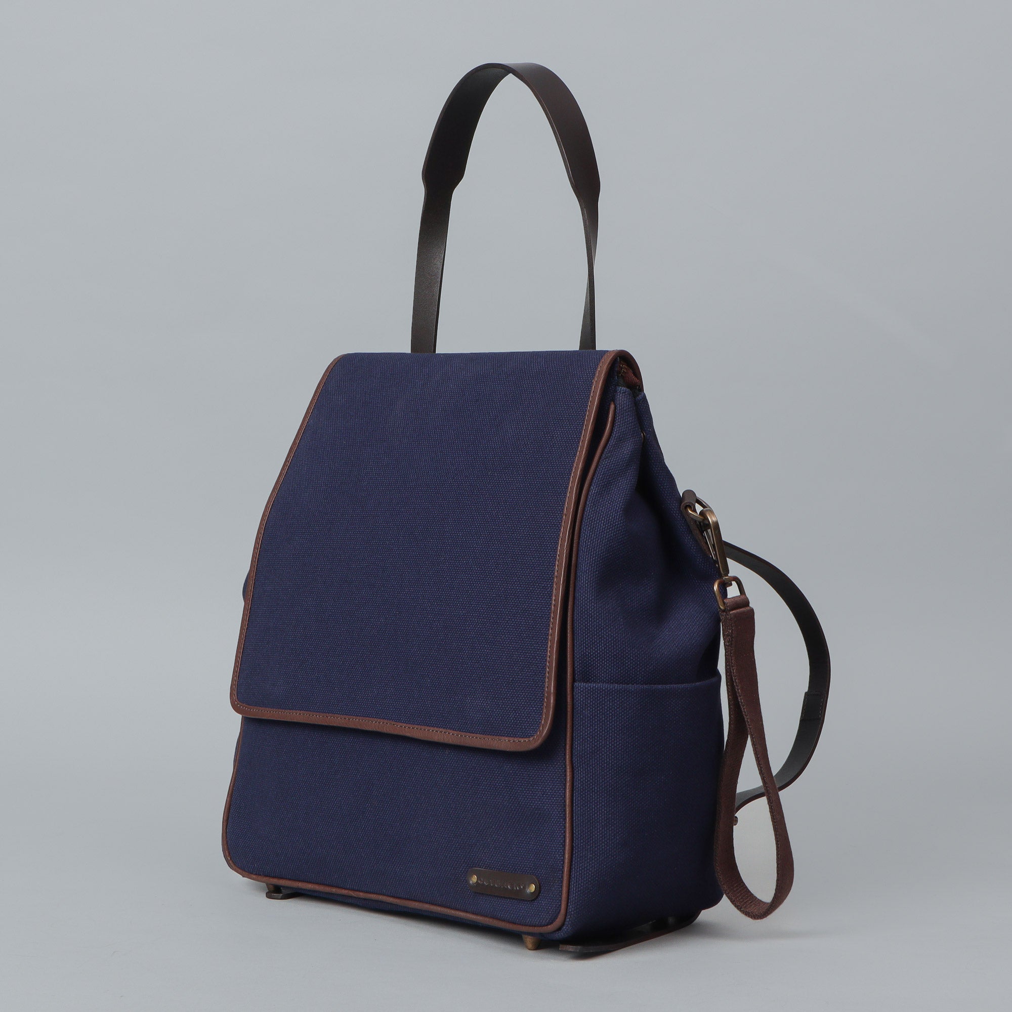 Stylish Donna Canvas Diaper Bag in durable cotton canvas with multiple pockets and leather straps, perfect for parents on the go.