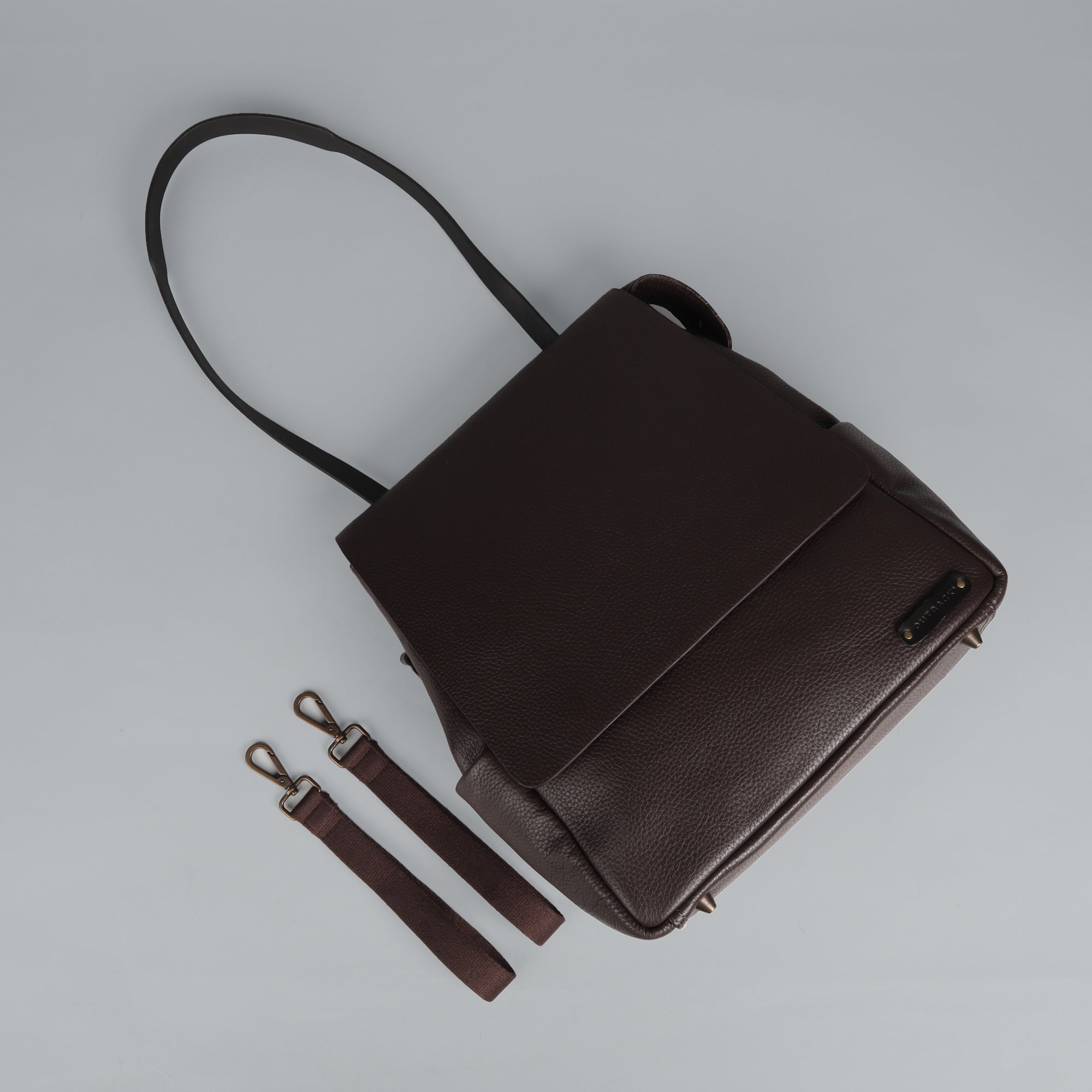 Donna Leather Diaper Bag in premium full grain leather with multiple pockets and versatile carrying options.