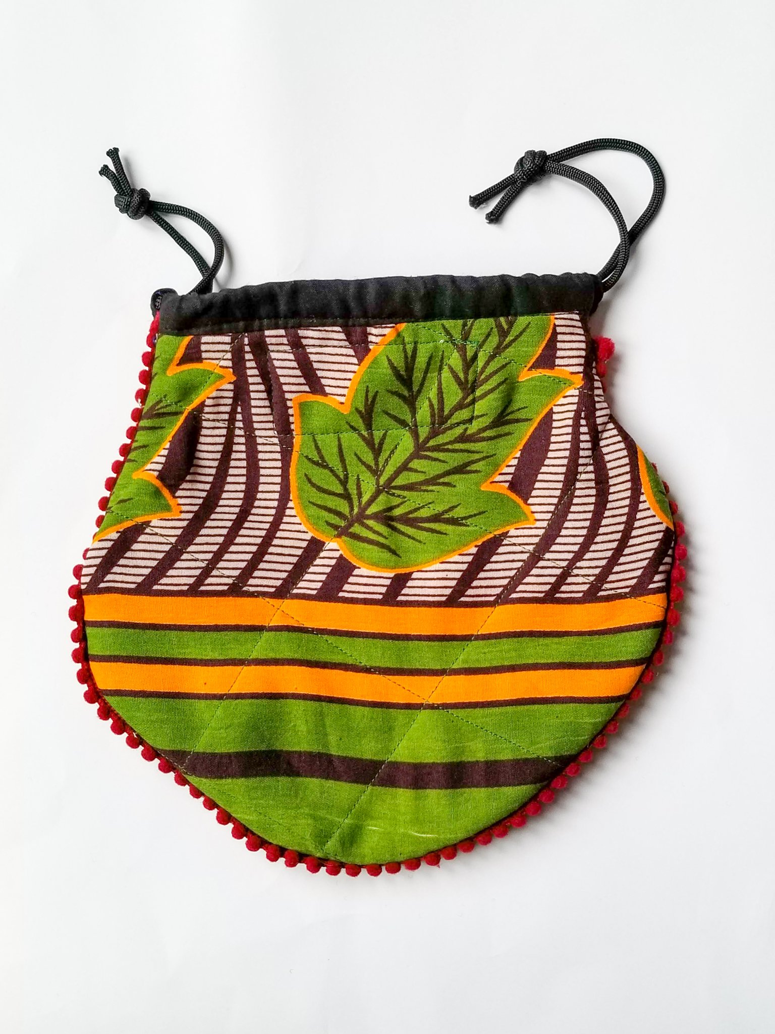 A colorful handcrafted drawstring sari pouch showcasing unique patterns and vibrant colors, perfect for storing small items.