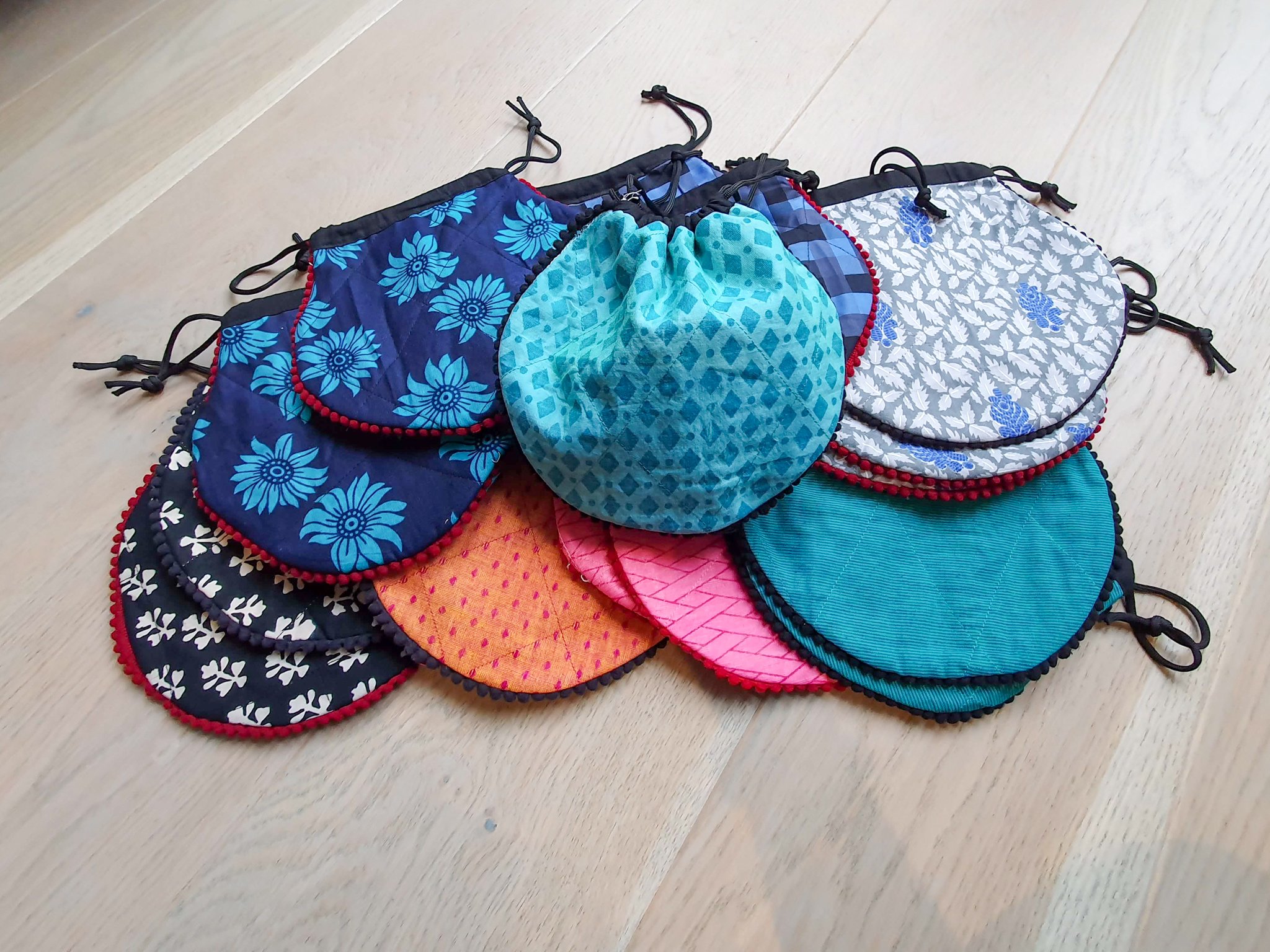 A colorful handcrafted drawstring sari pouch showcasing unique patterns and vibrant colors, perfect for storing small items.