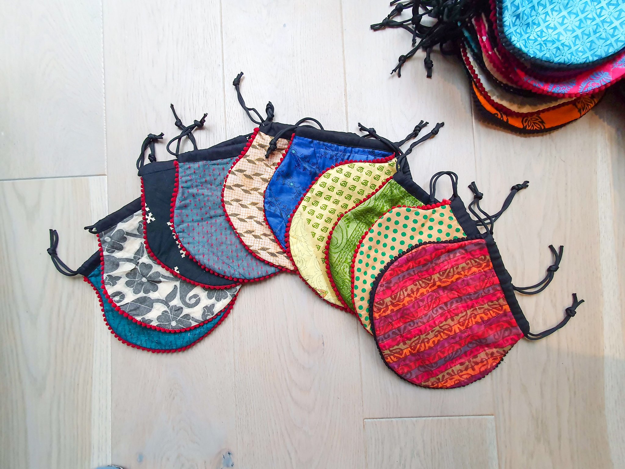 A colorful handcrafted drawstring sari pouch showcasing unique patterns and vibrant colors, perfect for storing small items.