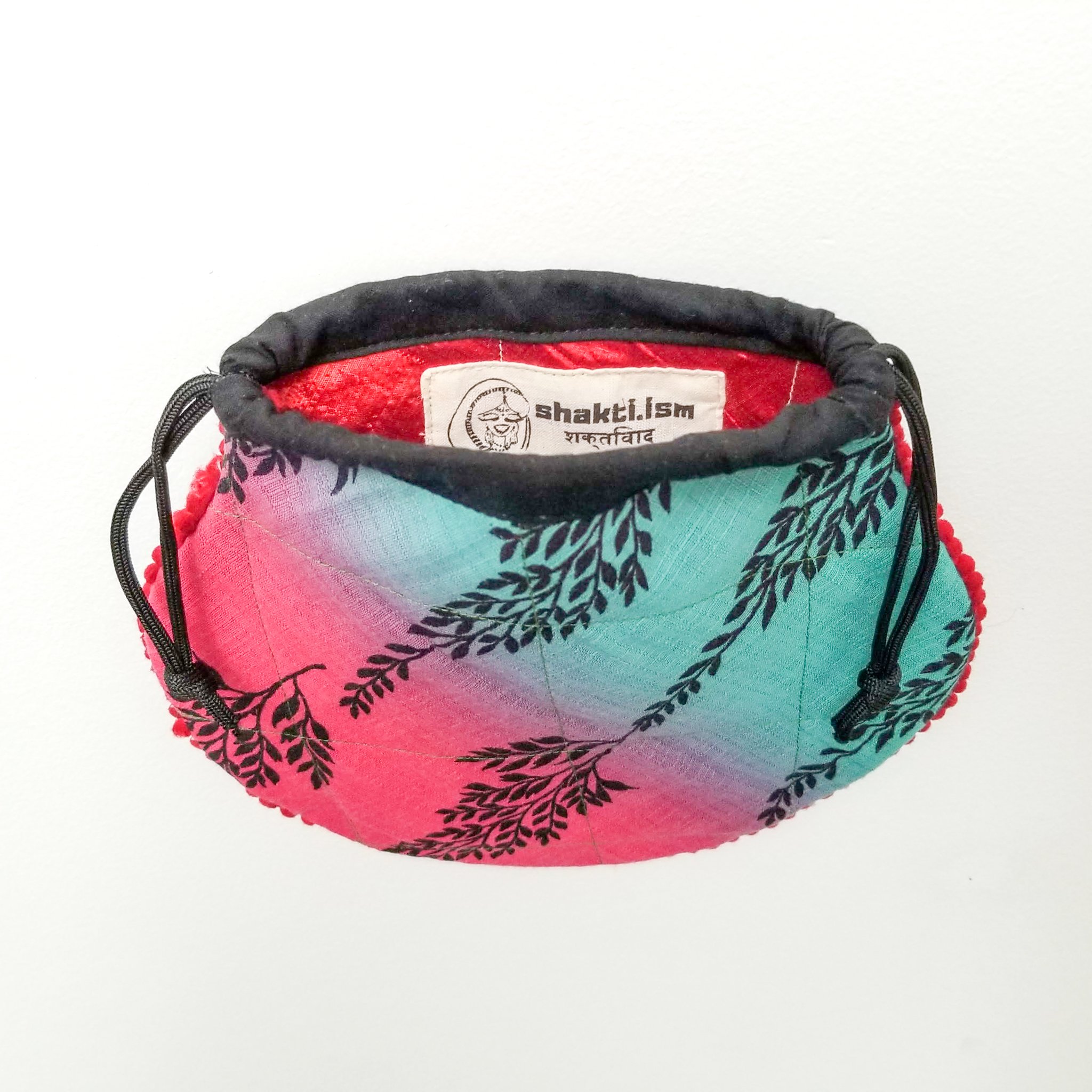 A colorful handcrafted drawstring sari pouch showcasing unique patterns and vibrant colors, perfect for storing small items.