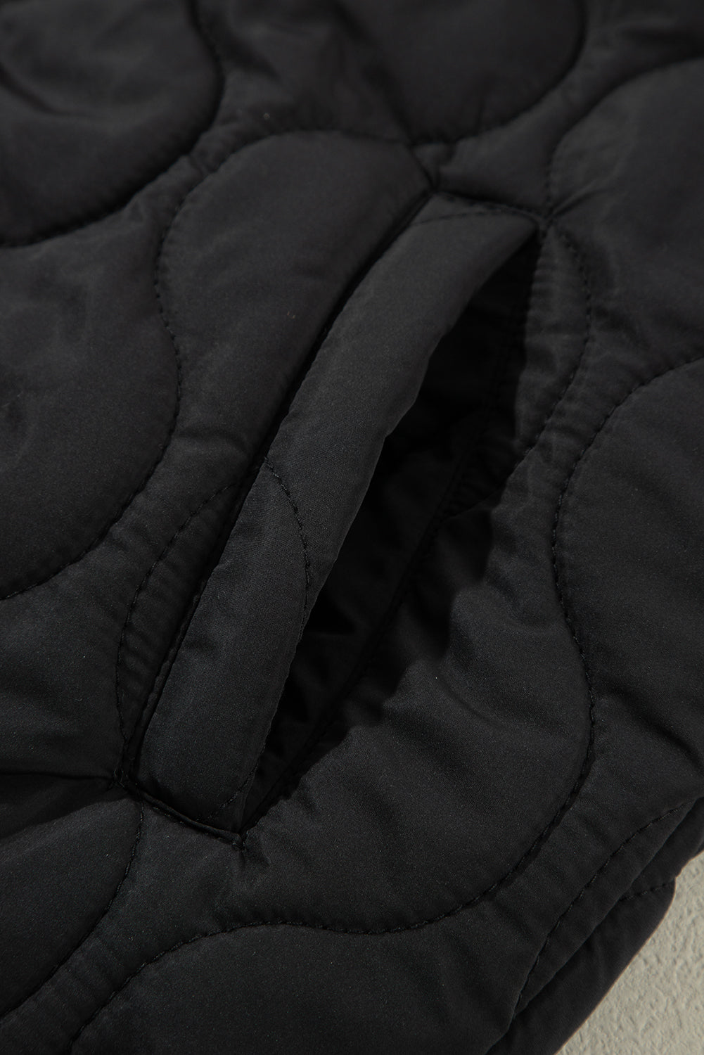 A stylish drawstring zip-up hooded vest coat in black, showcasing its adjustable drawstring and sleek design.