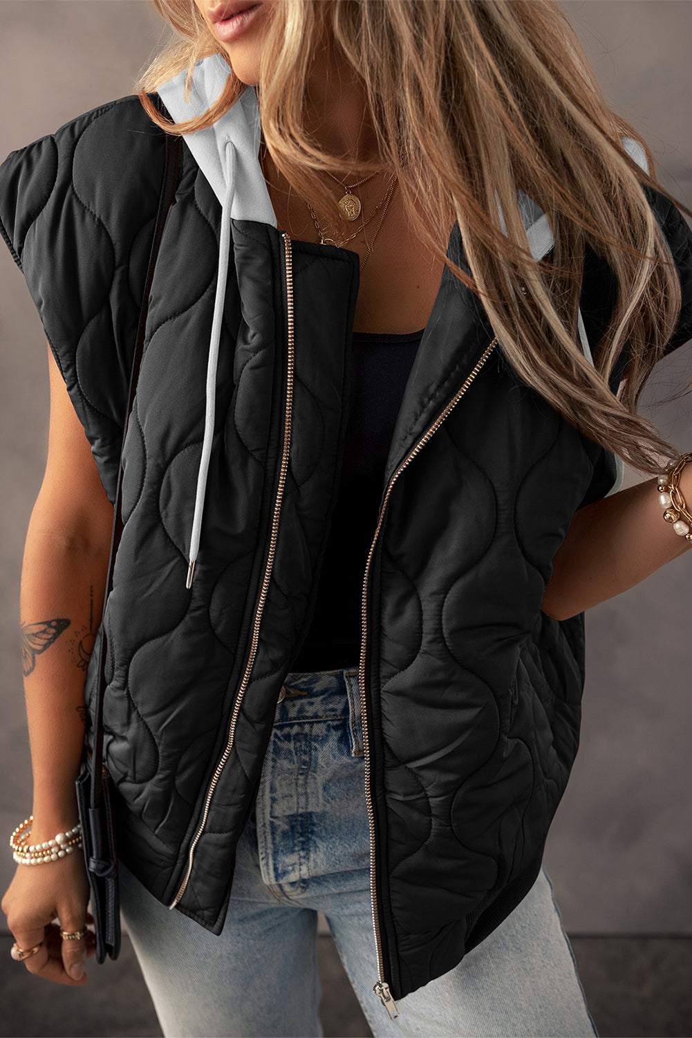 A stylish drawstring zip-up hooded vest coat in black, showcasing its adjustable drawstring and sleek design.