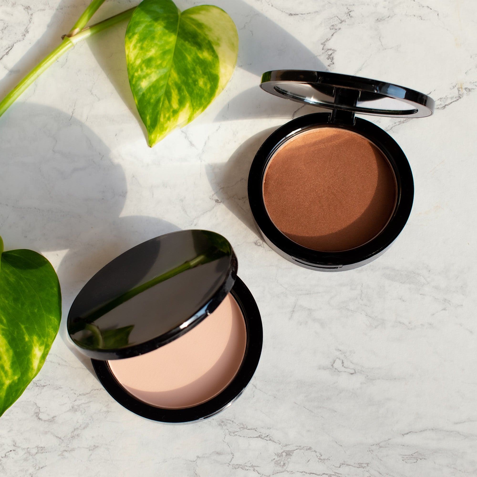 A compact of Dual Blend Powder Foundation in Ecru, showcasing its sleek design and powder texture, ideal for achieving a flawless complexion.