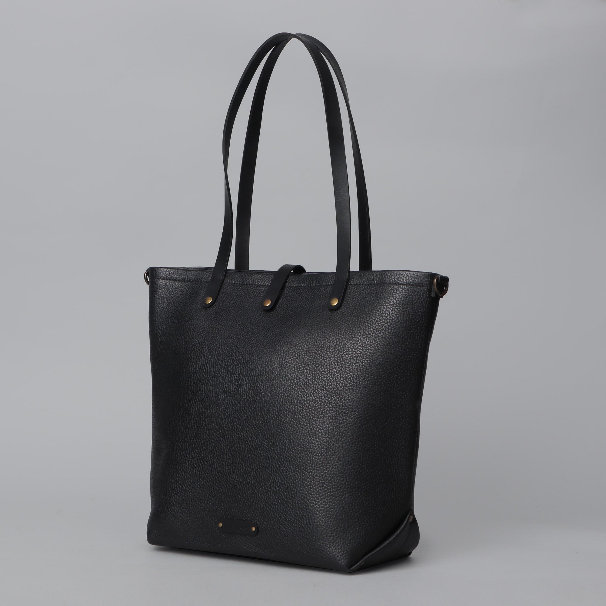 Dublin Leather Tote showcasing premium full grain leather, spacious compartments, and durable straps, perfect for laptops and daily essentials.