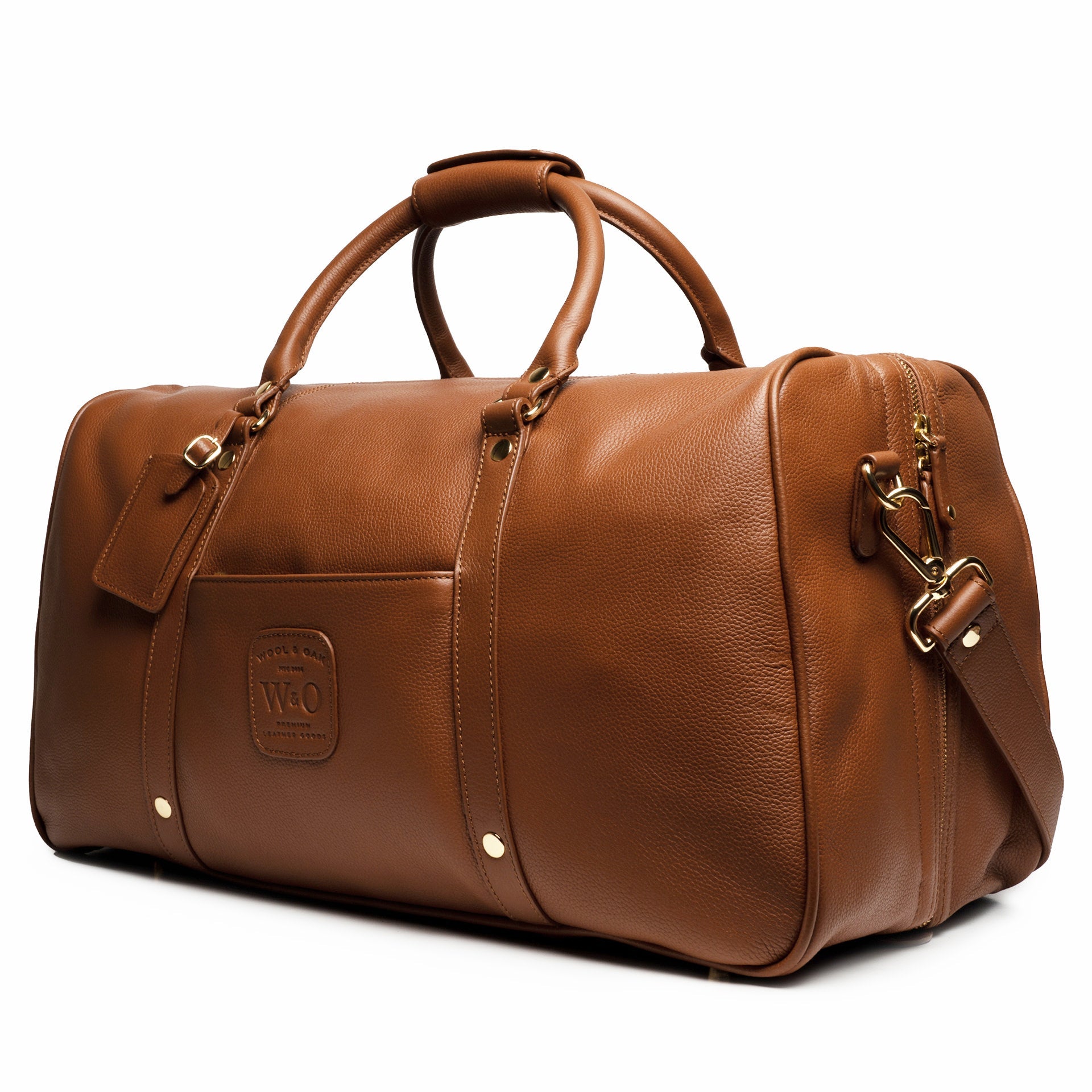 A stylish Duffle Suitcase 20" made of full grain leather with brass hardware, featuring removable walls for customizable compartments.