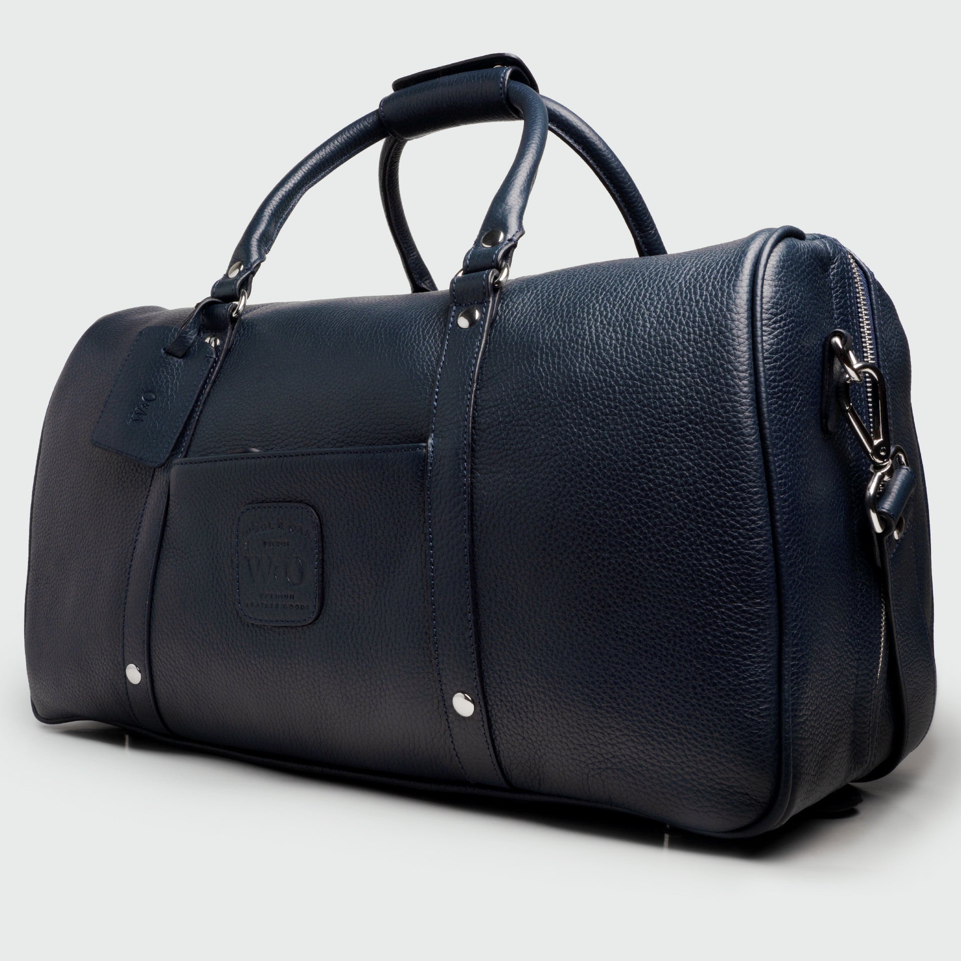 A stylish Duffle Suitcase 20" made of full grain leather with brass hardware, featuring removable walls for customizable compartments.