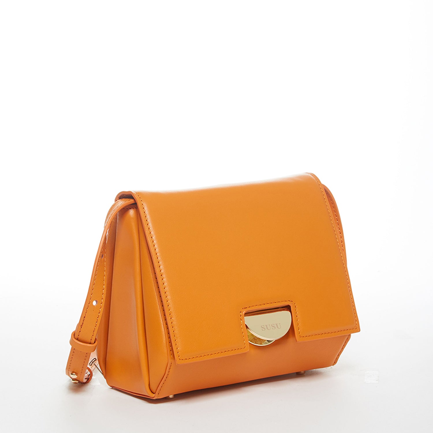 Elizabeth Dark Orange Leather Saddle Bag with gold hardware and adjustable strap, showcasing its geometric shape and teal interior.