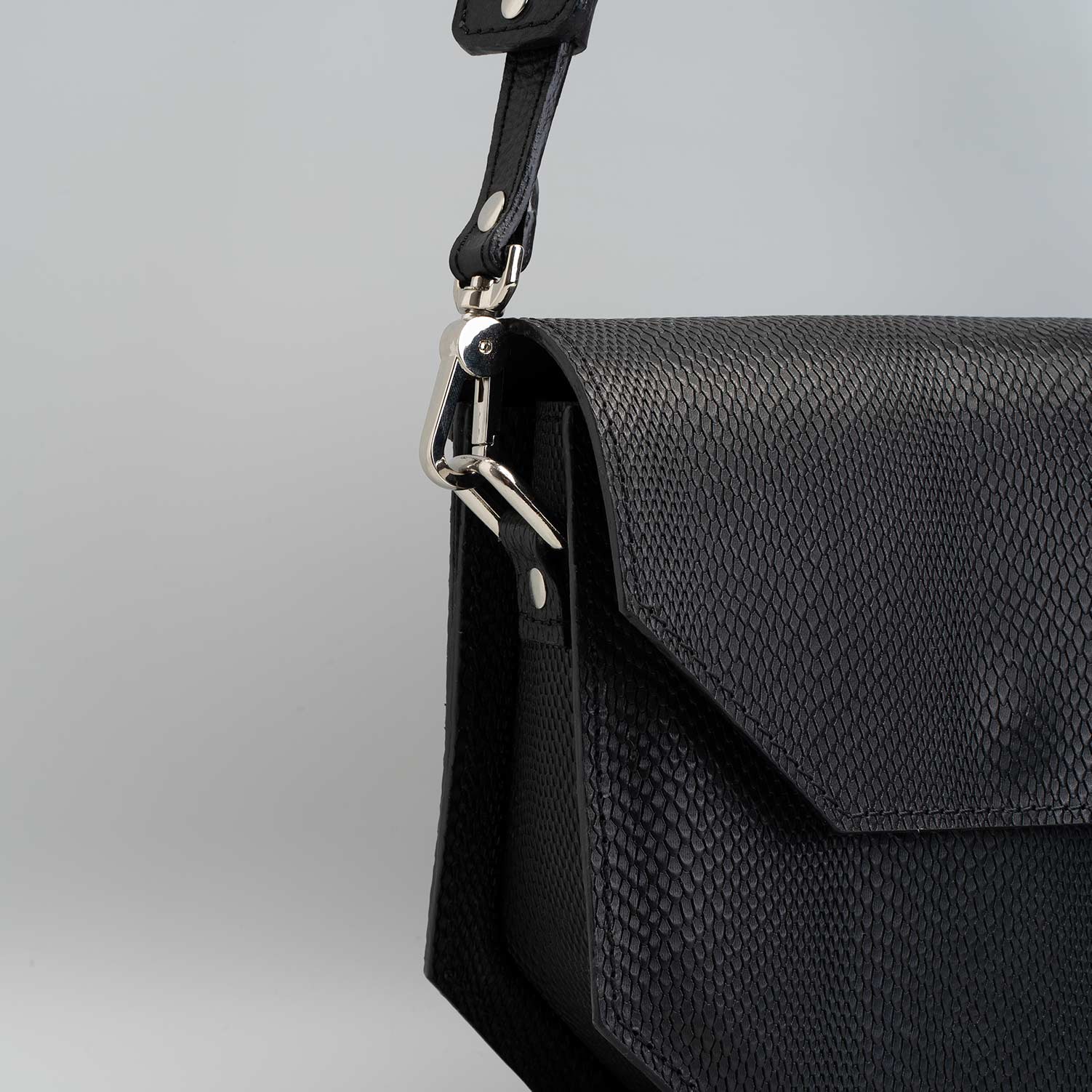 Hypatia embossed snake print purse made from premium Italian leather, featuring a hexagon shape and silver hardware.