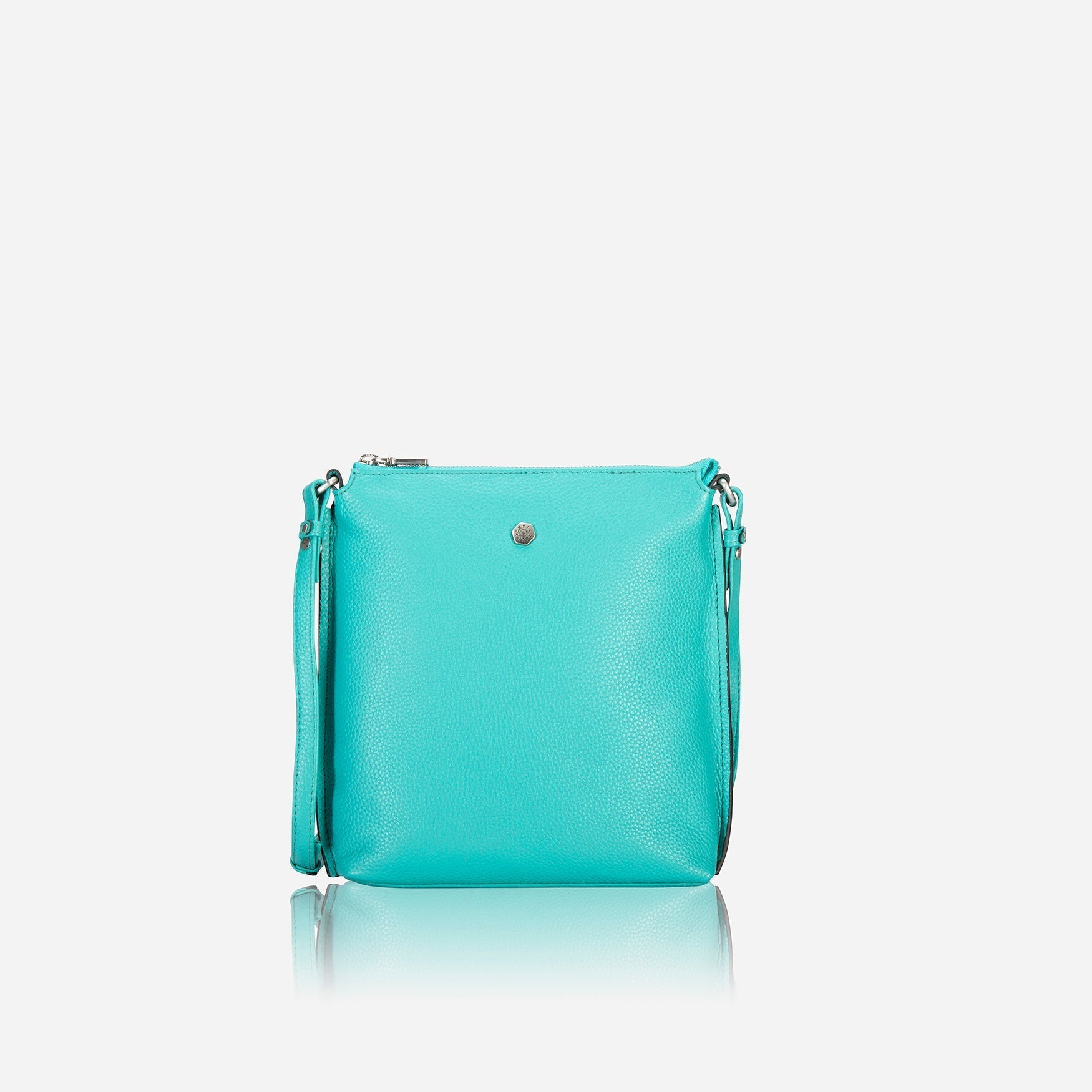 Essentials Crossbody Bag in Calypso Teal, showcasing its stylish design and textured material.