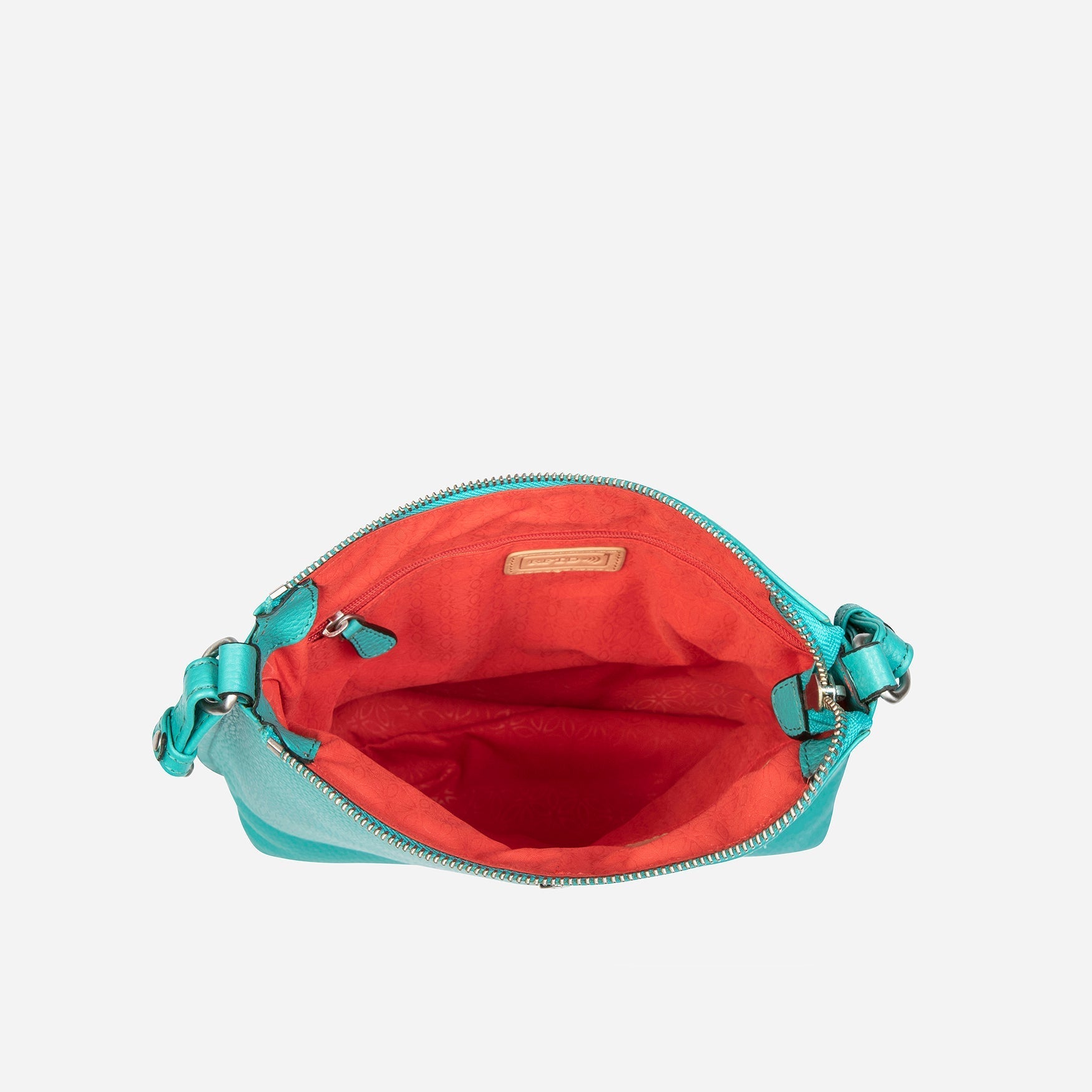 Essentials Crossbody Bag in Calypso Teal, showcasing its stylish design and textured material.