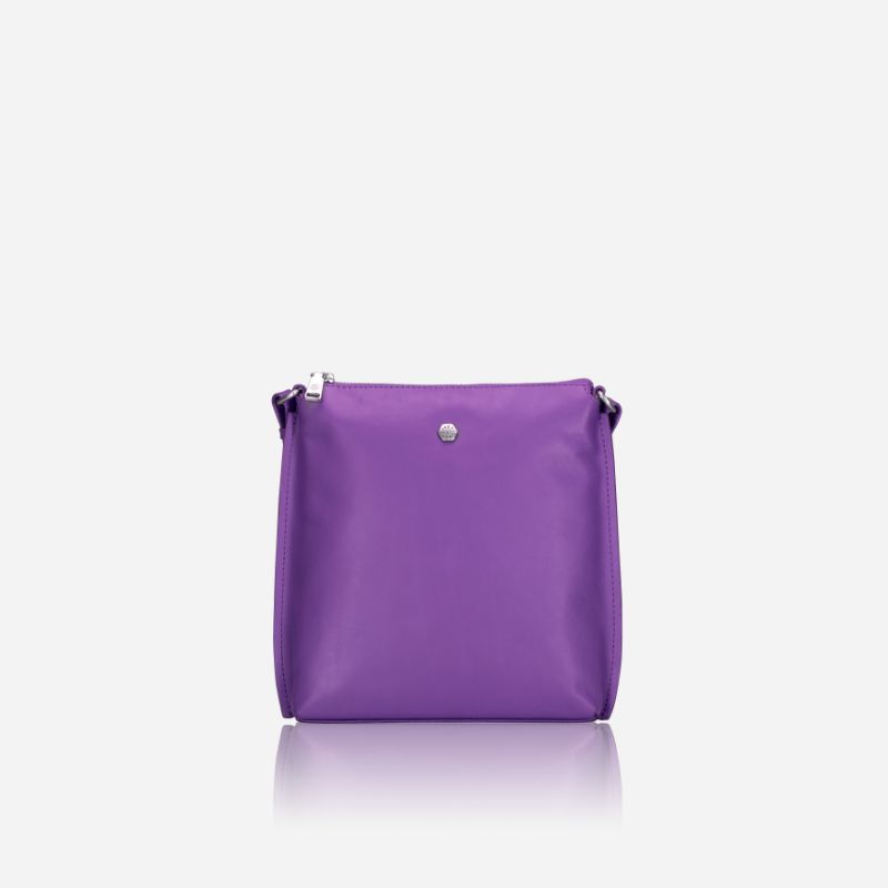 Essentials Crossbody bag in Electric Iris color, made of premium leather, showcasing its stylish design and adjustable strap.