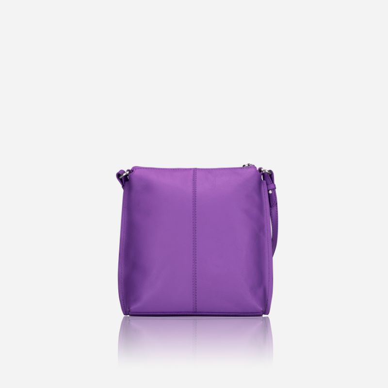 Essentials Crossbody bag in Electric Iris color, made of premium leather, showcasing its stylish design and adjustable strap.