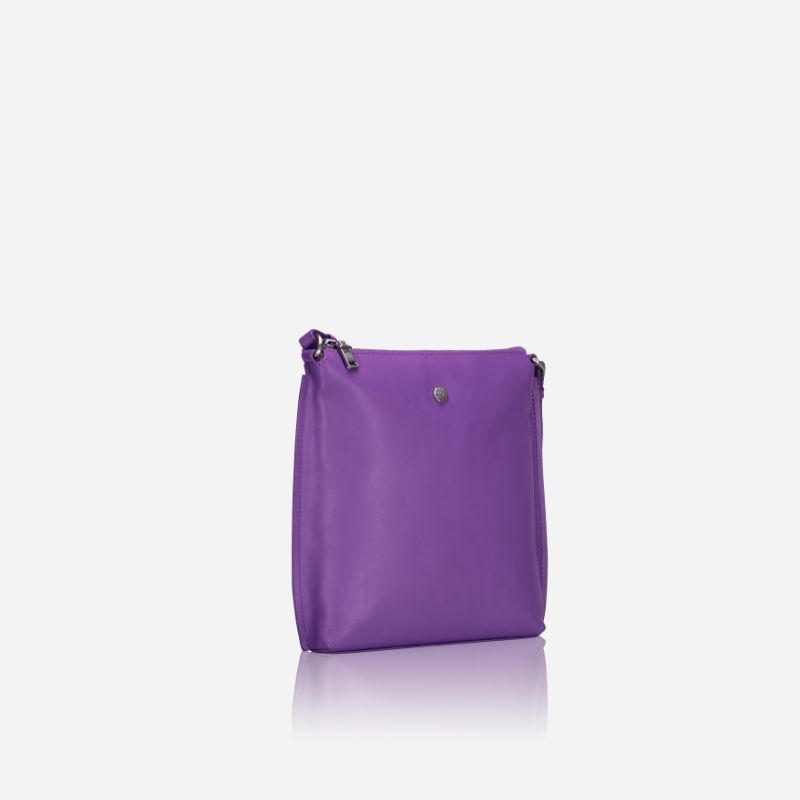 Essentials Crossbody bag in Electric Iris color, made of premium leather, showcasing its stylish design and adjustable strap.