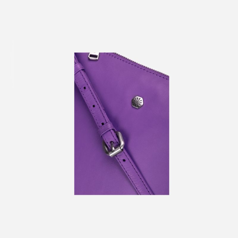 Essentials Crossbody bag in Electric Iris color, made of premium leather, showcasing its stylish design and adjustable strap.