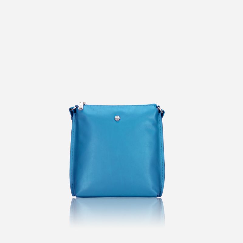 Essentials Crossbody bag in Sea Glass color, made of leather, showcasing its stylish design and spacious interior.