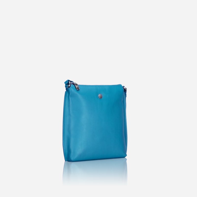 Essentials Crossbody bag in Sea Glass color, made of leather, showcasing its stylish design and spacious interior.