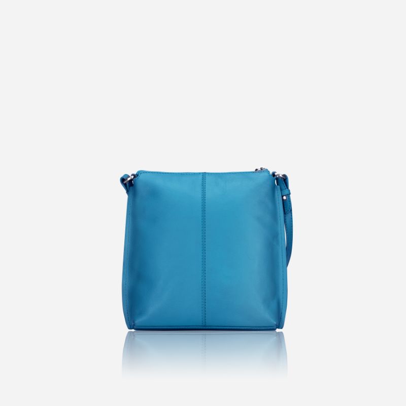 Essentials Crossbody bag in Sea Glass color, made of leather, showcasing its stylish design and spacious interior.