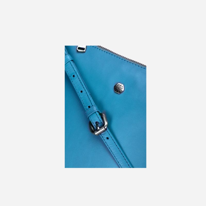 Essentials Crossbody bag in Sea Glass color, made of leather, showcasing its stylish design and spacious interior.