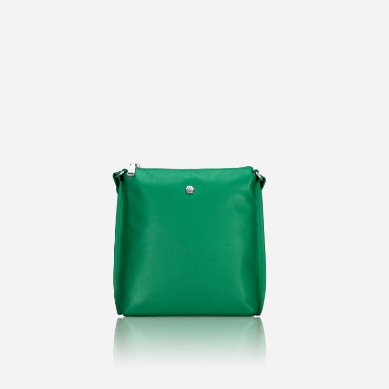 Essentials Crossbody bag in vibrant Spring Basil leather, showcasing its stylish design and adjustable strap.