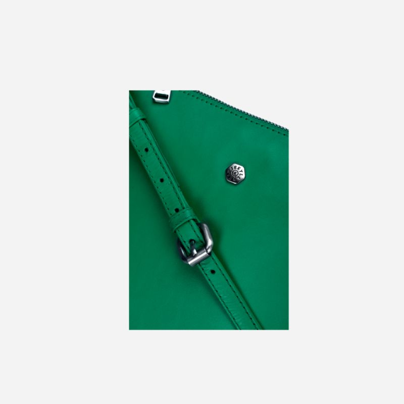 Essentials Crossbody bag in vibrant Spring Basil leather, showcasing its stylish design and adjustable strap.