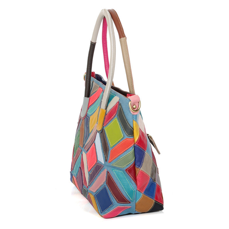 A colorful leather handbag featuring European American style with stitching details, medium size, and a zipper opening.