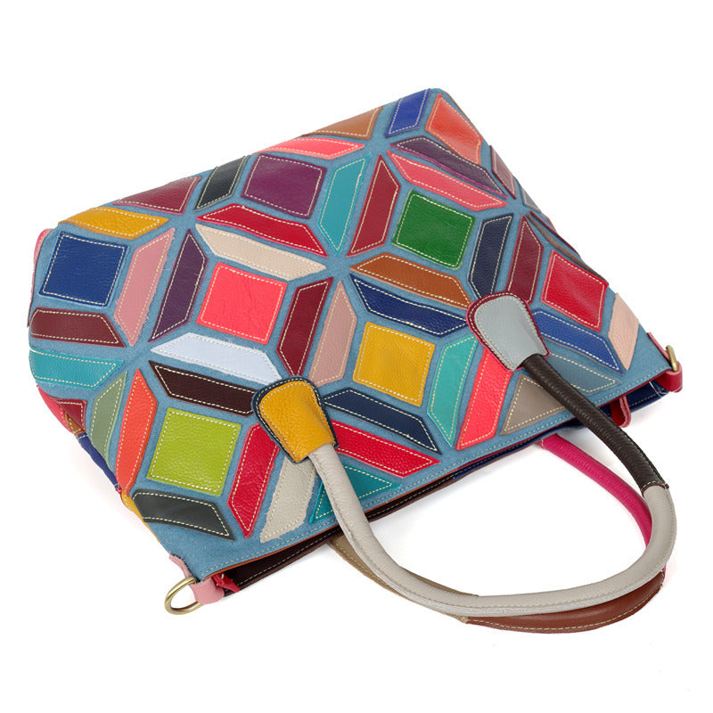 A colorful leather handbag featuring European American style with stitching details, medium size, and a zipper opening.