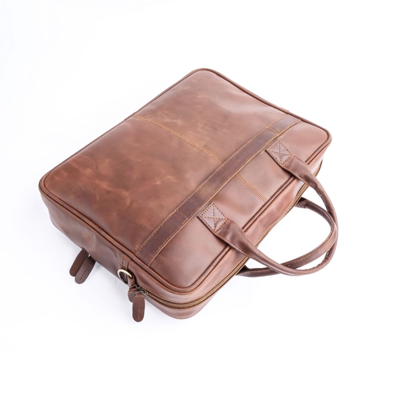 Tan brown leather laptop bag with vintage two-tone design, featuring adjustable shoulder strap and multiple compartments.