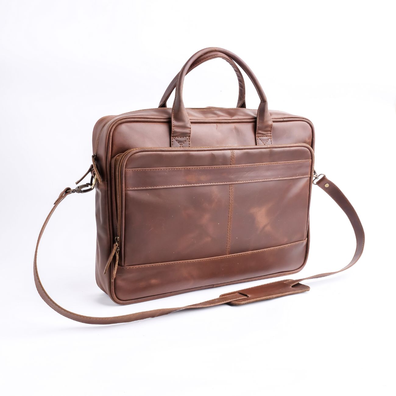 Tan brown leather laptop bag with vintage two-tone design, featuring adjustable shoulder strap and multiple compartments.