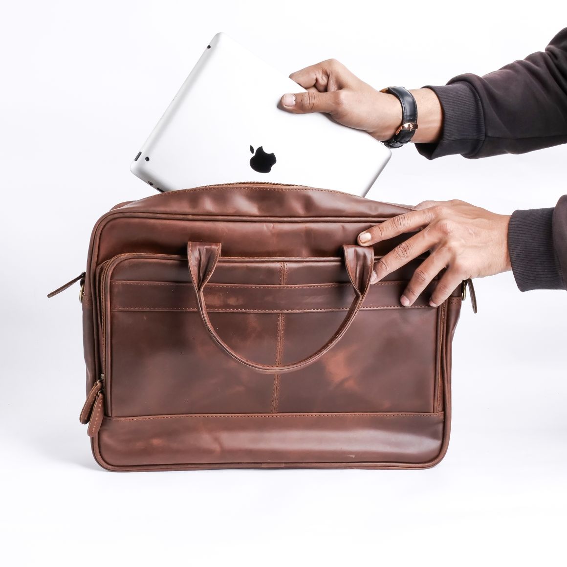 Tan brown leather laptop bag with vintage two-tone design, featuring adjustable shoulder strap and multiple compartments.