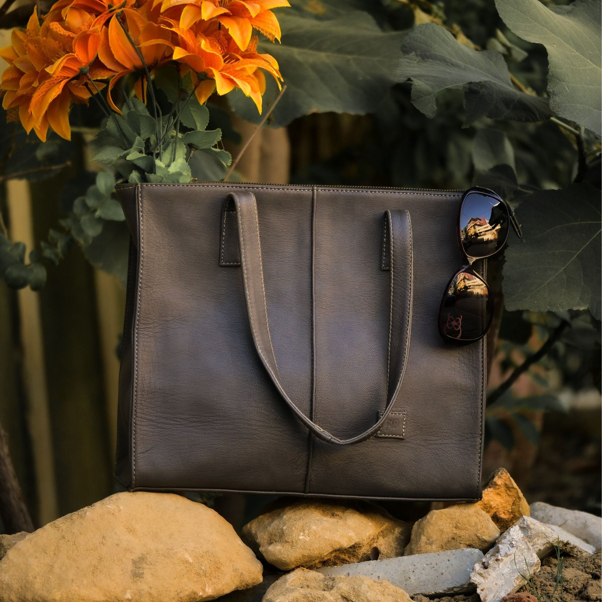 Everyday Women's Leather Zipper Tote Bag in Graphite Grey, showcasing its spacious design and premium cow leather material.