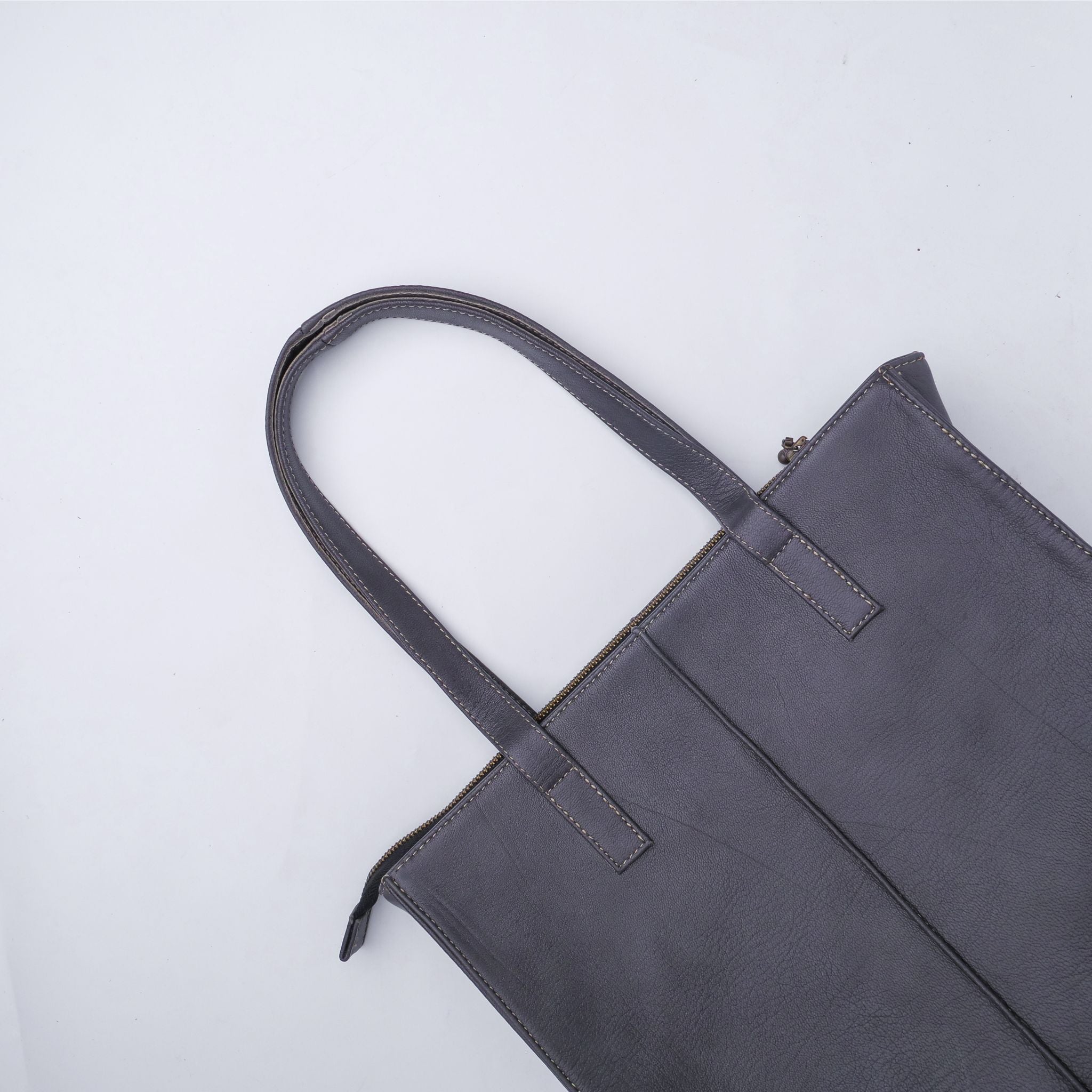 Everyday Women's Leather Zipper Tote Bag in Graphite Grey, showcasing its spacious design and premium cow leather material.