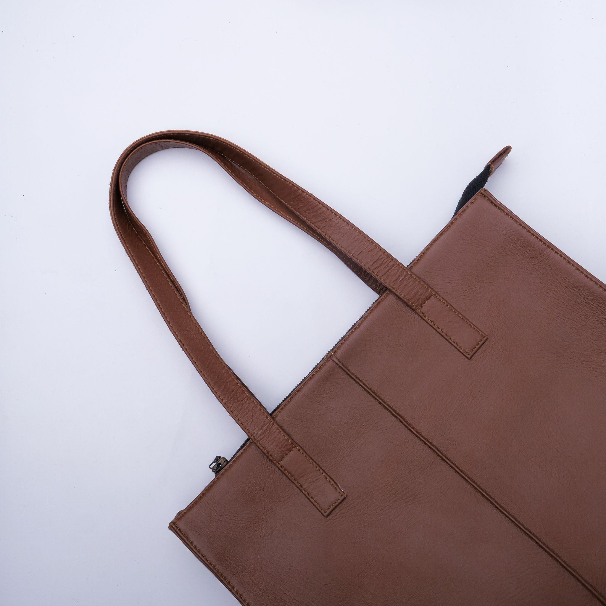 Everyday Women's Leather Zipper Tote Bag in Tan Brown, showcasing its spacious design and premium cow leather material.