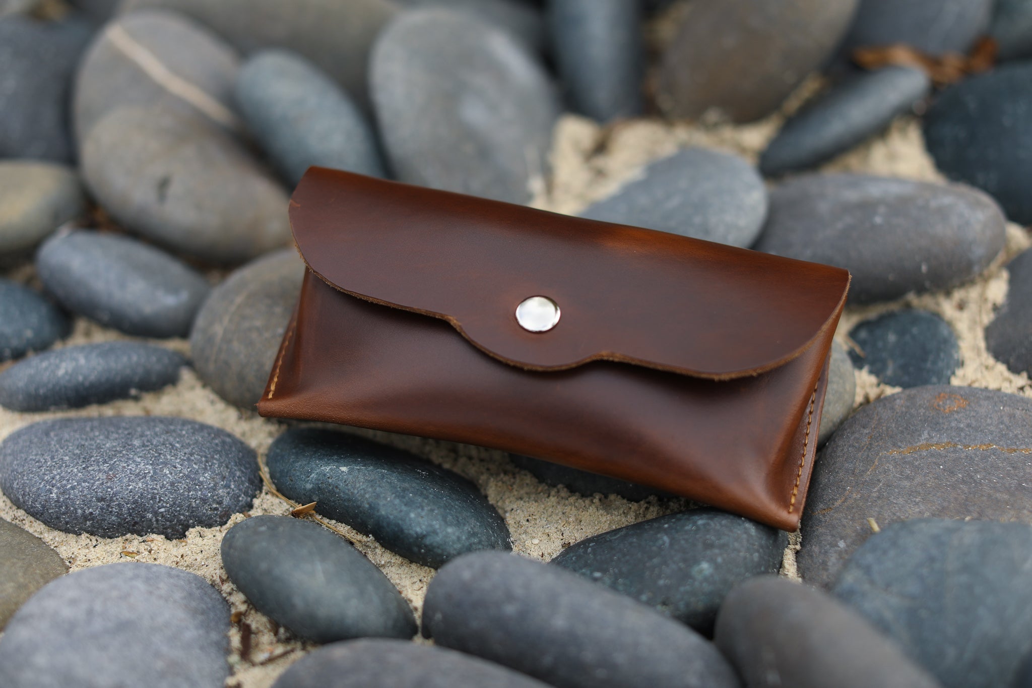 Premium leather eyeglasses case designed for universal fit, featuring a magnetic snap closure and personalized options.