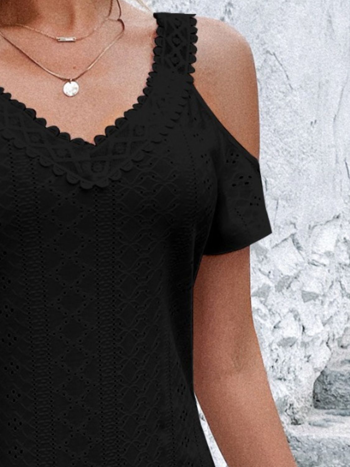 A stylish Eyelet V-Neck Cold Shoulder Mini Dress featuring eyelet detailing and a slightly stretchy fit, perfect for summer outings.