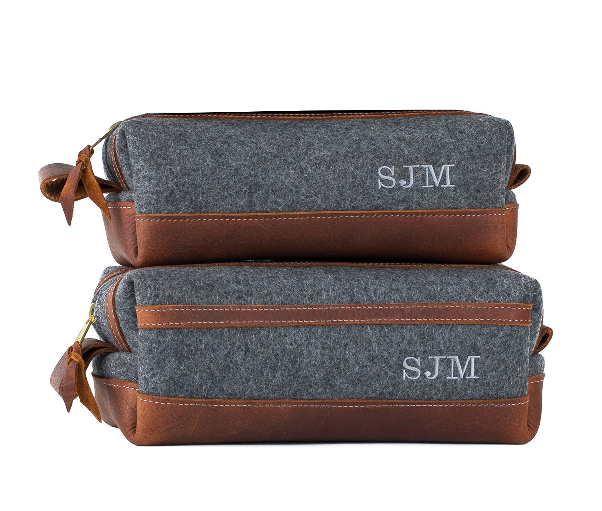 Stylish felt and leather toiletry bag with brass zippers and water-resistant liner, showcasing its unique design and personalization option.