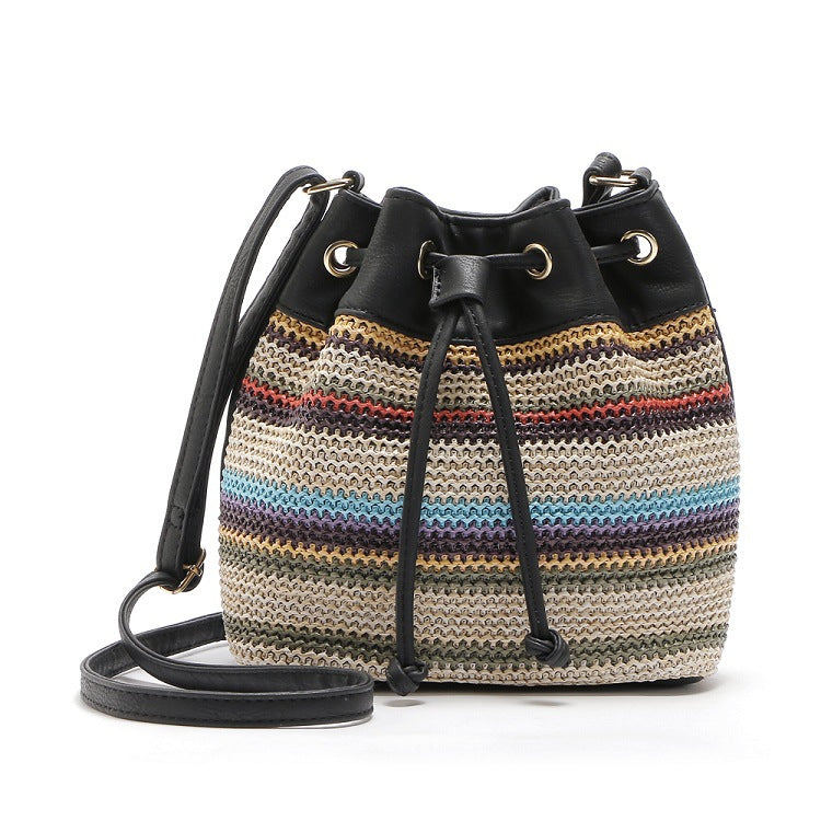 A stylish Female Fashion Simple Bohemian Wave Striped Messenger Bag featuring a trendy bucket design with a drawstring buckle closure and geometric pattern.