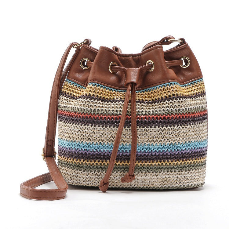 A stylish Female Fashion Simple Bohemian Wave Striped Messenger Bag featuring a trendy bucket design with a drawstring buckle closure and geometric pattern.