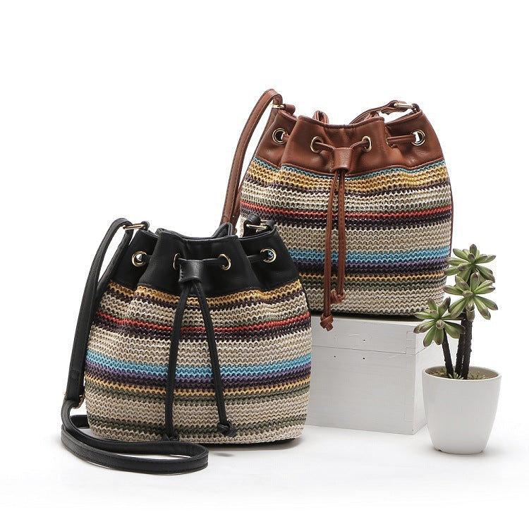 A stylish Female Fashion Simple Bohemian Wave Striped Messenger Bag featuring a trendy bucket design with a drawstring buckle closure and geometric pattern.