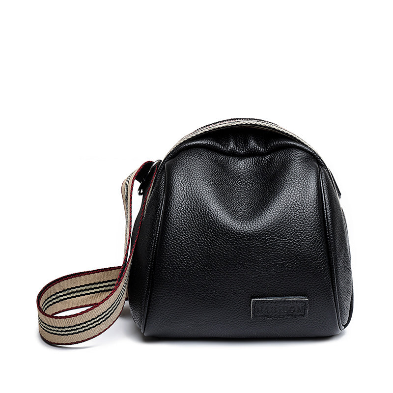 Female shell shape one-shoulder messenger bag made of PU leather with a zipper closure and single shoulder strap.