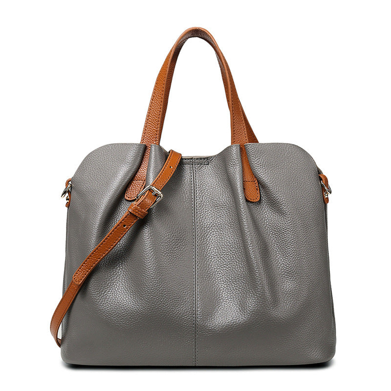 First Layer Cowhide Large Bag in elegant design, showcasing its soft leather texture and spacious interior with multiple pockets.